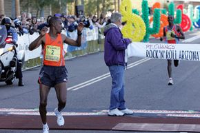 Winner Terefae Yae glances behind the finish line after completing the Arizona Rock 'n' Roll Marathon.