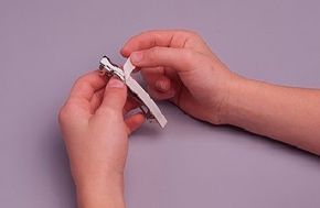 Photo of a ribbon being glued against a barrette