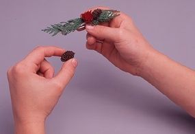 Photo of some natural material being glued to a barrette