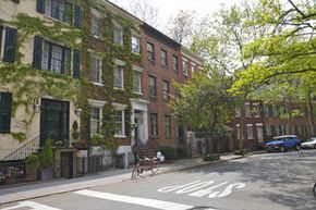 A row of apartment buildings on a street.