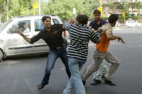 Two pedestrians fight a driver and hispassenger after a near-collision in New Delhi, India. Road rage is a dangerous behavior pattern that can affect any of us at any given time.  See more car safety pictures.