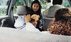 Kids playing on road trip as mom scolds. 