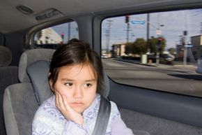 young girl in car looking bored