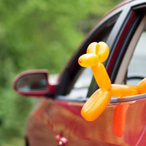 balloon animal in a red car