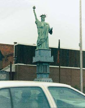The Junk Statue of Liberty in McRae, Georgia, was fashioned partly out of a tree stump, Styrofoam, and green paint.