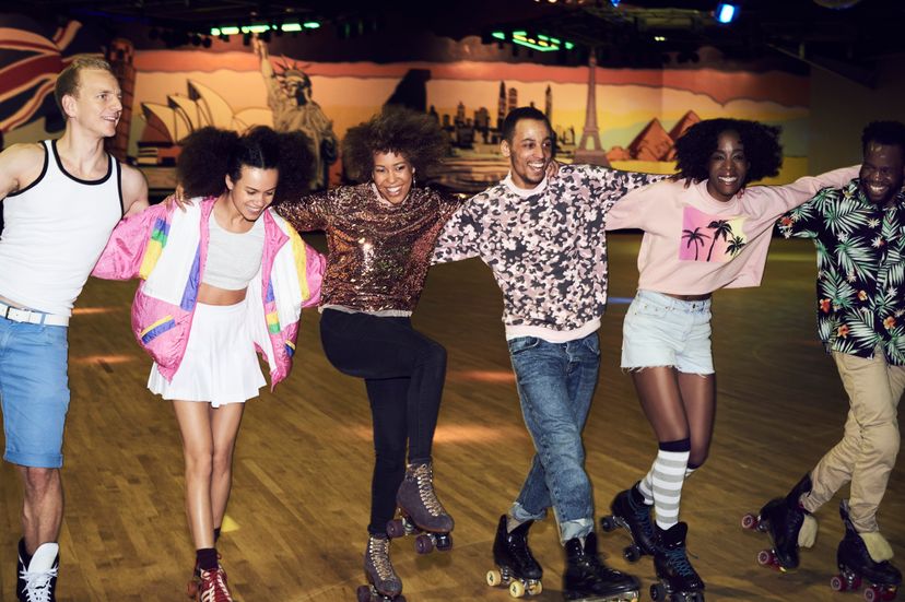 Six people roller skate together