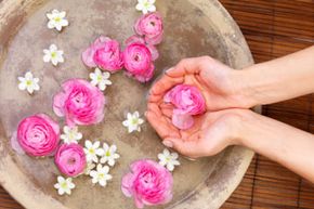 Human hands holding red roses in spa