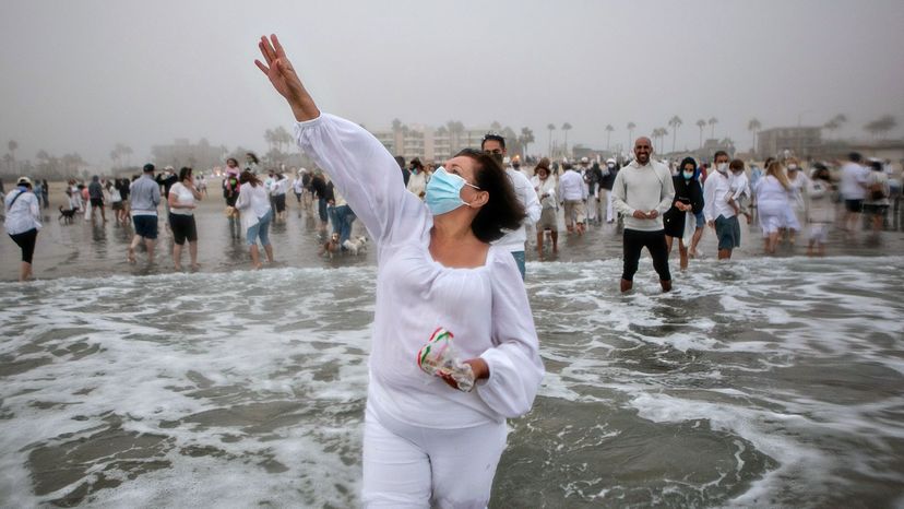 People take part in a Tashlich ceremony