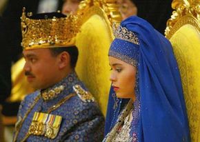 Bruneian Crown Prince Al-Muhtadee Billah Bolkiah and his bride, commoner Sarah Salleh, sit in the throne chamber at the Balai Singgahsana, Indera Buana. See more pictures of Royality.