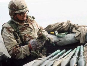 Capt. Jose R. Atencia, 77th Explosive Ordnance Disposal Unit, handles abandoned Iraqi RPG-7 High Explosive Anti-Tank (HEAT) rockets in the aftermath of Operation Desert Storm.