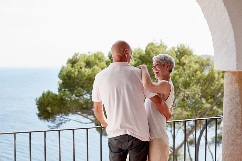 Happy couple standing on balcony