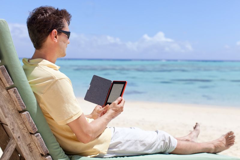 Reading e-Reader on beach
