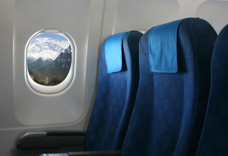 Airplane blue seats with a mountain view out the window
