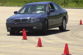 A test vehicle with its electronic stability control turned off slides over cones during a test in Auburn Hills, Mich., on July 16, 2003.
