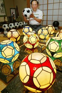 Stained glass isn’t only used for religious windows. Here, Kazuhide Yoshikawa displays his original soccer ball-shaped lampshades built of stained glass at Hirakata in Osaka Prefecture, western Japan.