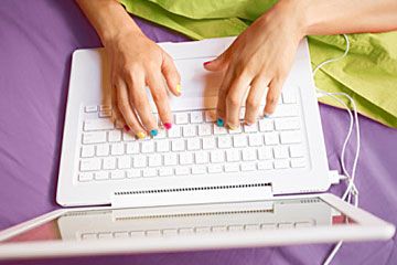 Hands typing on computer keyboard