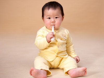baby with a thermometer in mouth