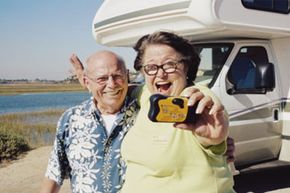 retired couple standing by RV