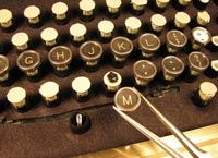 Jake von Slatt applies old typewriter key faces to the keycap in a moderncomputer keyboard.