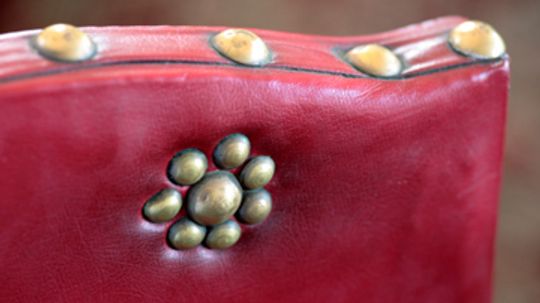 How can you decorate furniture with upholstery nails and tacks?