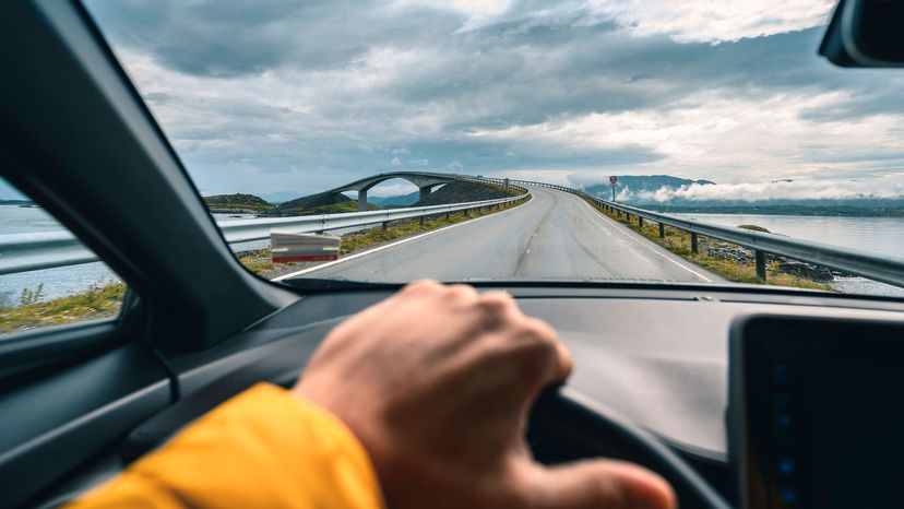 man driving along the Atlantic Ocean Road, Norway