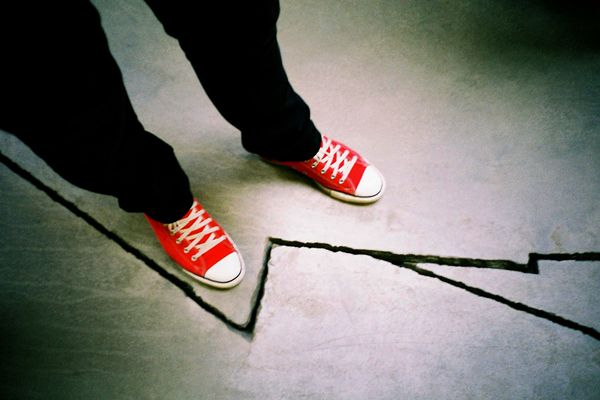 Person standing in front of crack