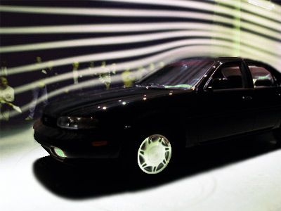 Car being tested in wind tunnel for aerodynamic performance.