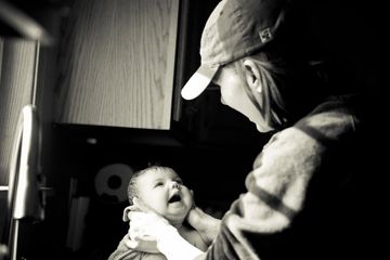 black and white photograph of woman holding infant