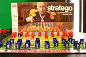 The Stratego box and board with game pieces laid out.