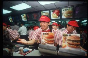 A worker takes an order from a customer in China's first McDonald's restaurant, back in 1992. According to the 'Big Mac Index,' global currency values can be measured by looking at the price of a Big Mac in various countries.