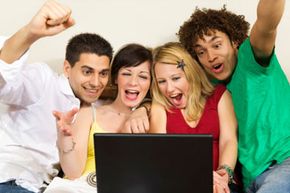 Group of friends watching TV on laptop