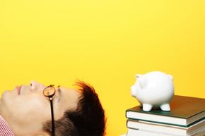 student with books and piggy banks