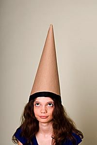 girl wearing dunce hat