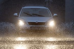 A car drives through floodwater in Prague.