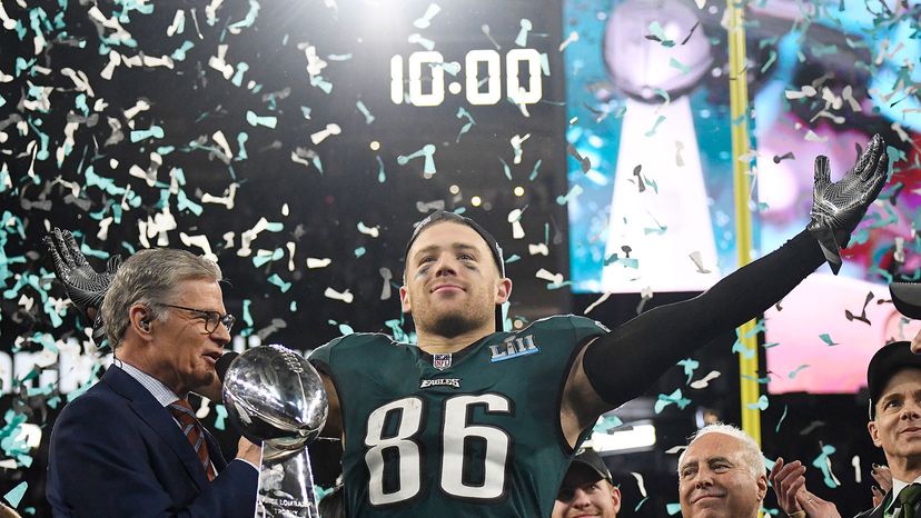 Zach Ertz (No. 86) of the Philadelphia Eagles celebrates with the Lombardi Trophy and talks with commentator Dan Patrick after the Eagles defeated the New England Patriots in Super Bowl LII in Minneapolis, Minnesota. 