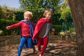 boys playing superheroes outdoors