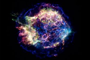 A composite image of supernova remnant Cassiopeia A, with x-rays in red, green and blue and optical data in gold.