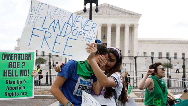 Women protest outdoors for better education.