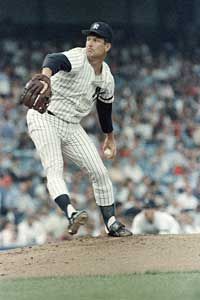 Tommy John pitches during a 1986 game at Yankee Stadium, more than a decade after his career-saving surgery.