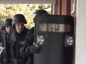 A SWAT team prepares to enter a building during an exercise simulating a hostage situation.  See more police pictures.