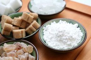 Different types of sugar in bowls.