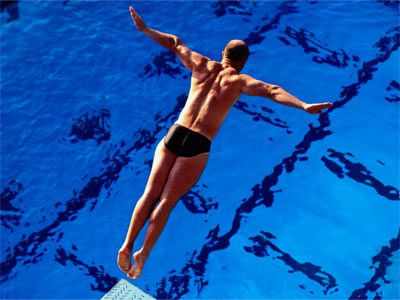 Man diving in spandex briefs