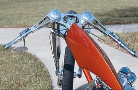 The custom-built machined billet handlebars on this chopper further illustrate the bike's streamlined appearance.
