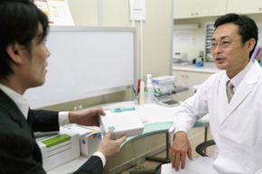 Man selling pharmaceutical supplies to doctor. 