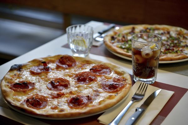 Pizzas and drink on table