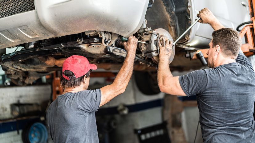 mechanics inspecting car