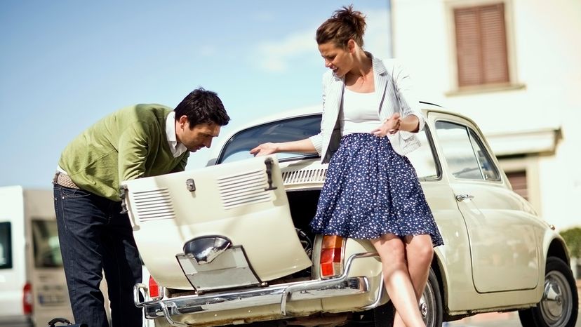 woman and man inspecting car