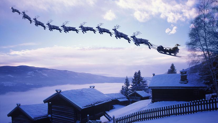 santa and reindeer flying through the night