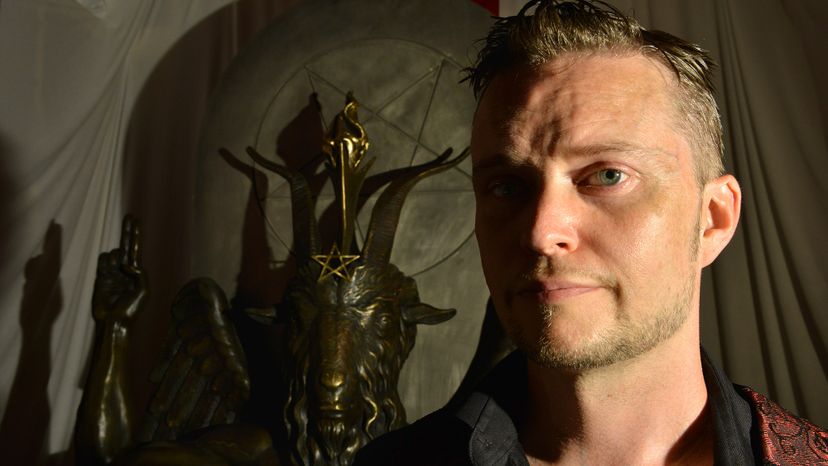 Satanic Temple spokesperson Lucien Greaves stands in front of a statue of Baphomet. The church is known for its outspokenness on social and political issues. The Washington Post/Getty Images