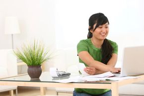 A woman with a calculator and a computer.